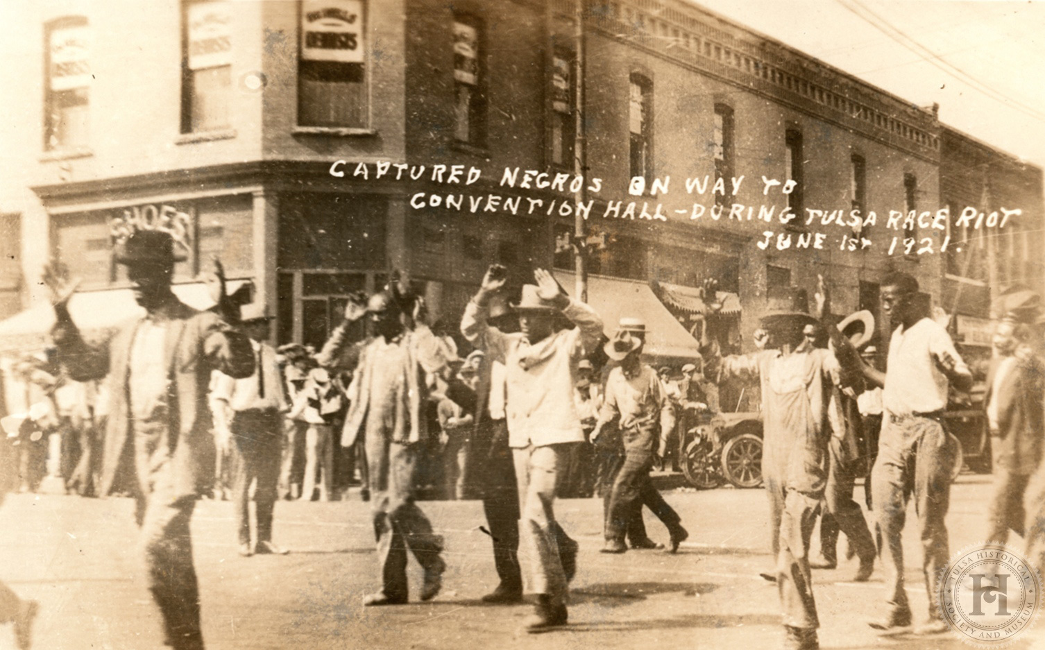 This image a 1920s-era postcard created from a photo of Black Tulsans being led to a detention center after the events of the 1921 Tulsa Massacre. Courtesy: Tulsa Historical Society & Museum.
