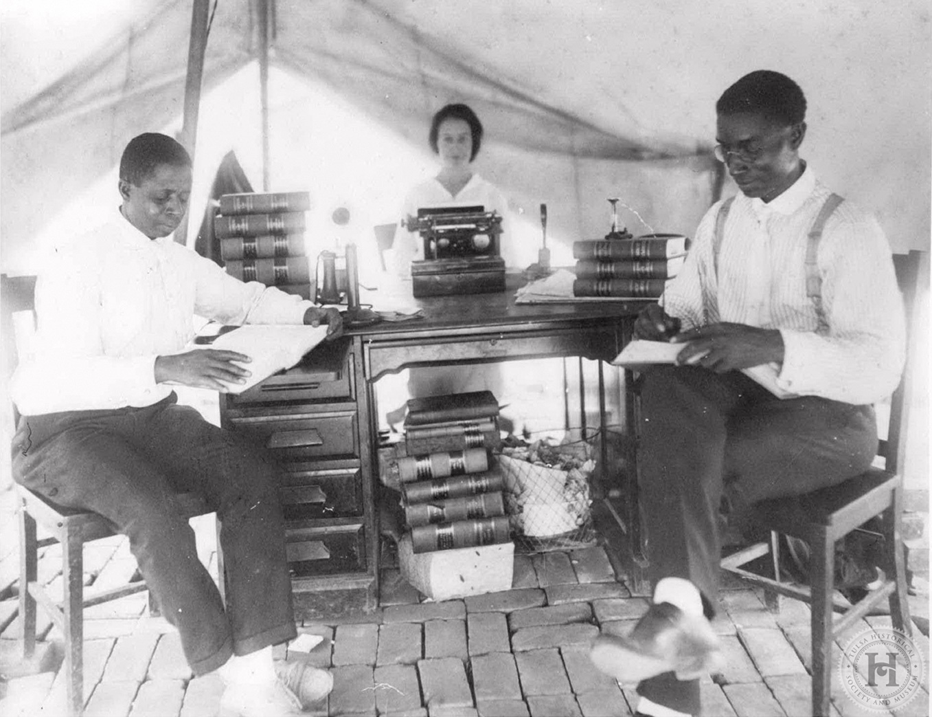This photograph shows attorney B.C. Franklin and two other Tulsa residents in a makeshift law office.